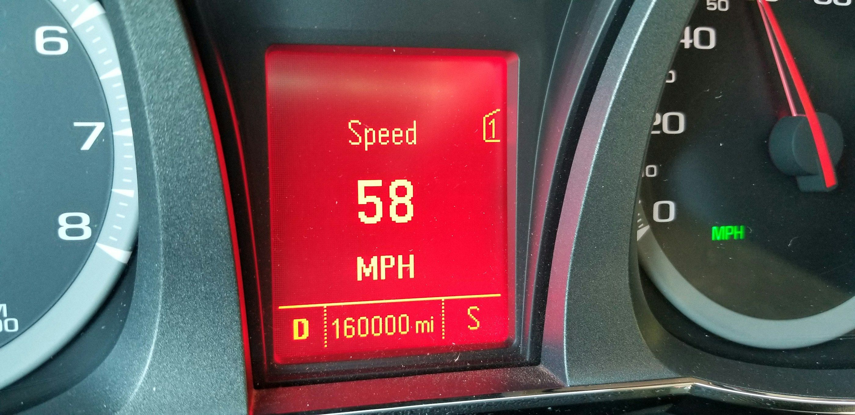 A dashboard display showing 160,000 miles on the odometer